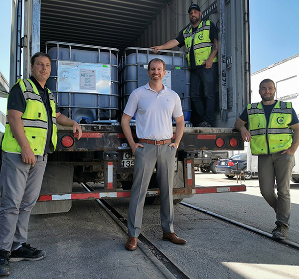 Work men standing in front of a truck